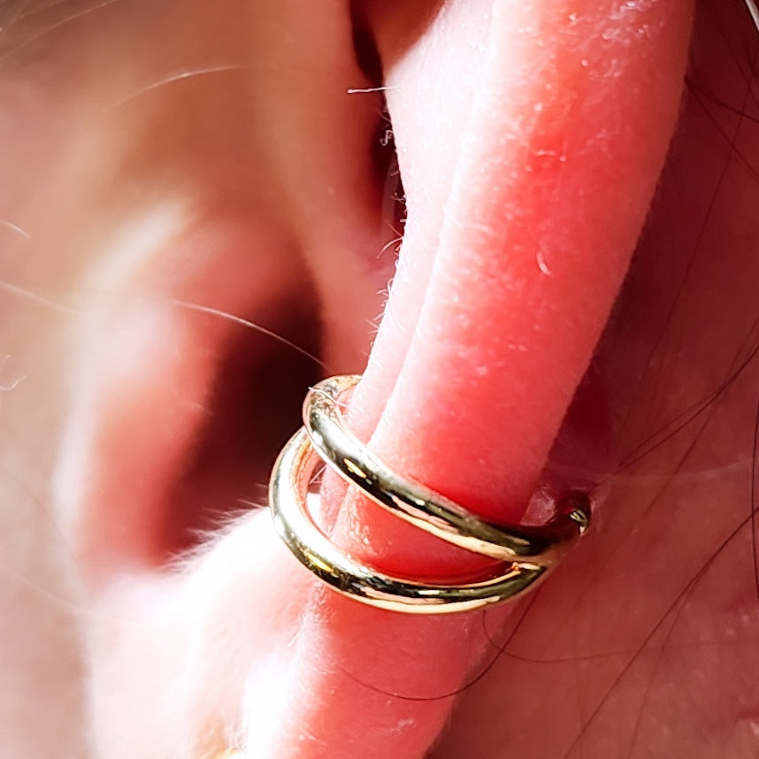 Gold split seam ring worn in an ear piercing