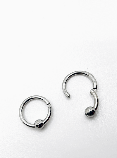 Polished titanium captive bead rings shown open and closed
