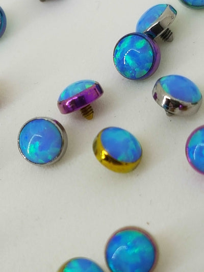 Close-up of blue opal-look jewelry ends in anodized settings