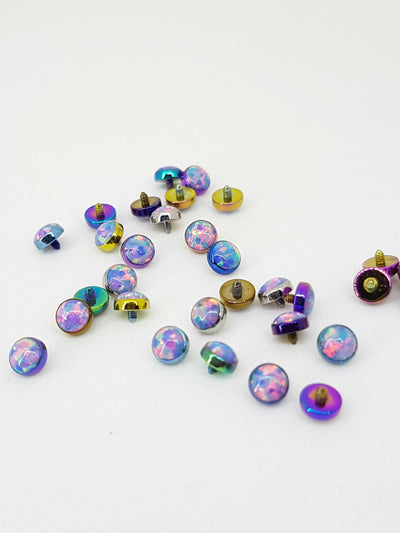 Pastel opal-look jewelry ends in multicoloured titanium settings