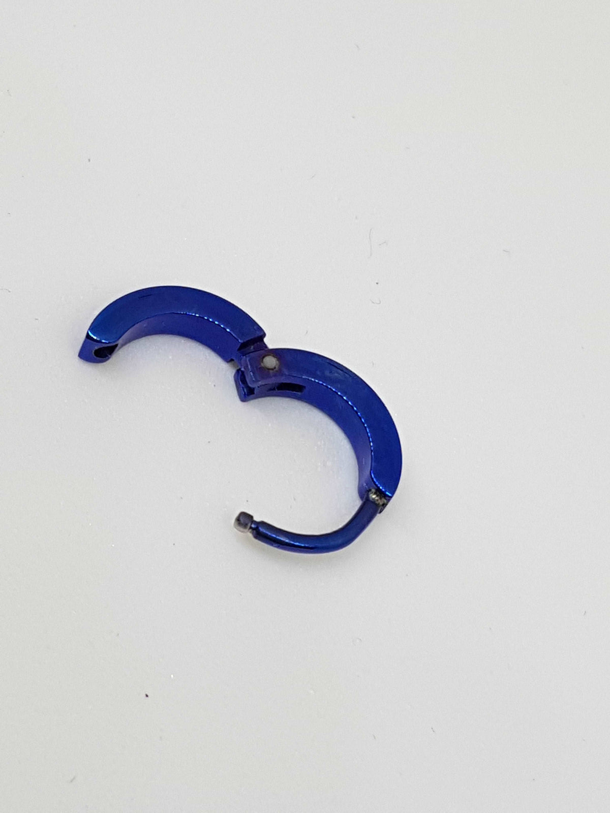 Blue titanium clicker with its hinged section open