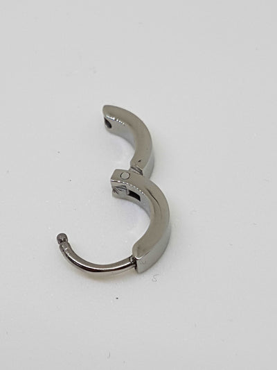Polished titanium clicker with its hinged section open