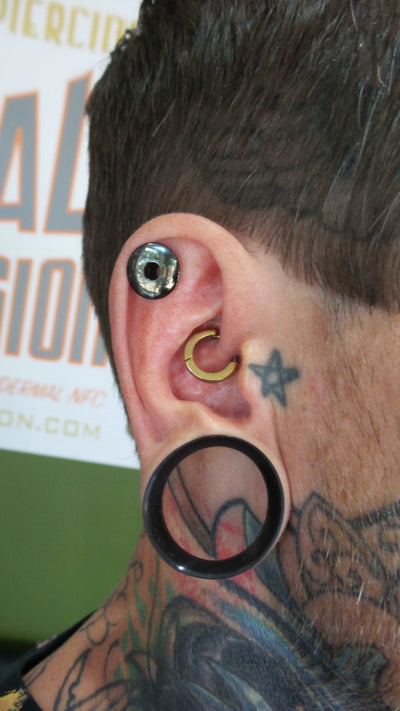 Titanium clicker worn in a daith piercing