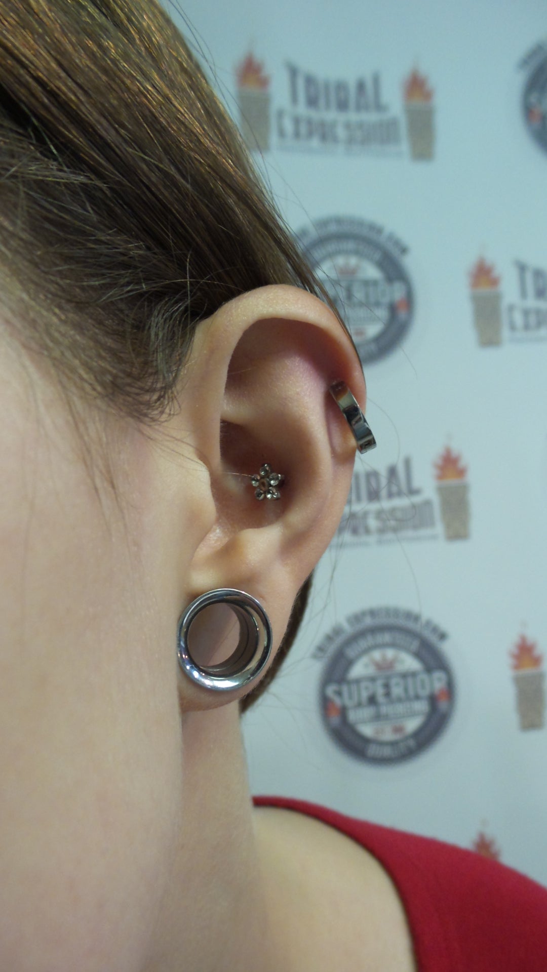 Titanium clicker worn in an upper-ear piercing