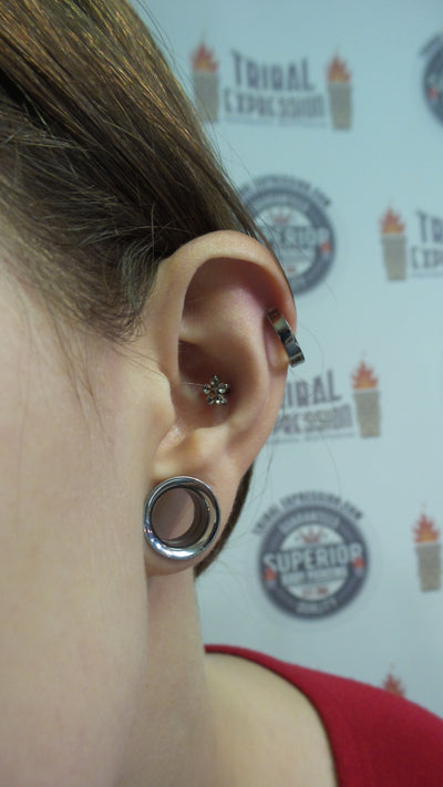 Titanium clicker worn in an upper-ear piercing