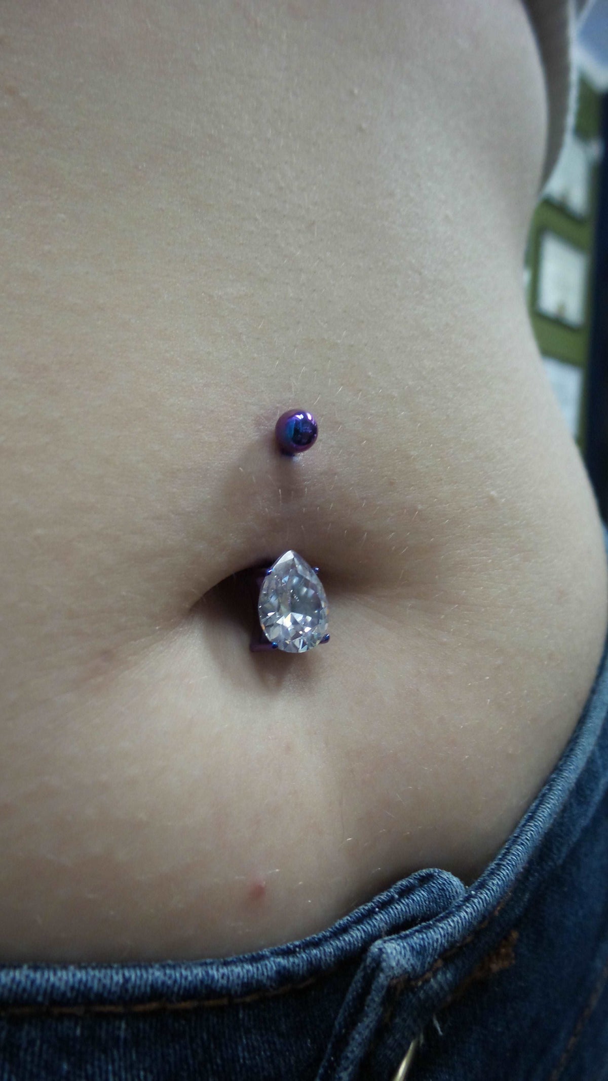 Teardrop gemstone jewelry worn in a navel piercing