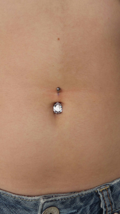 Freshly pierced navel with our implant grade titanium Curved barbell with a pear shaped clear cubic zirconia in the center