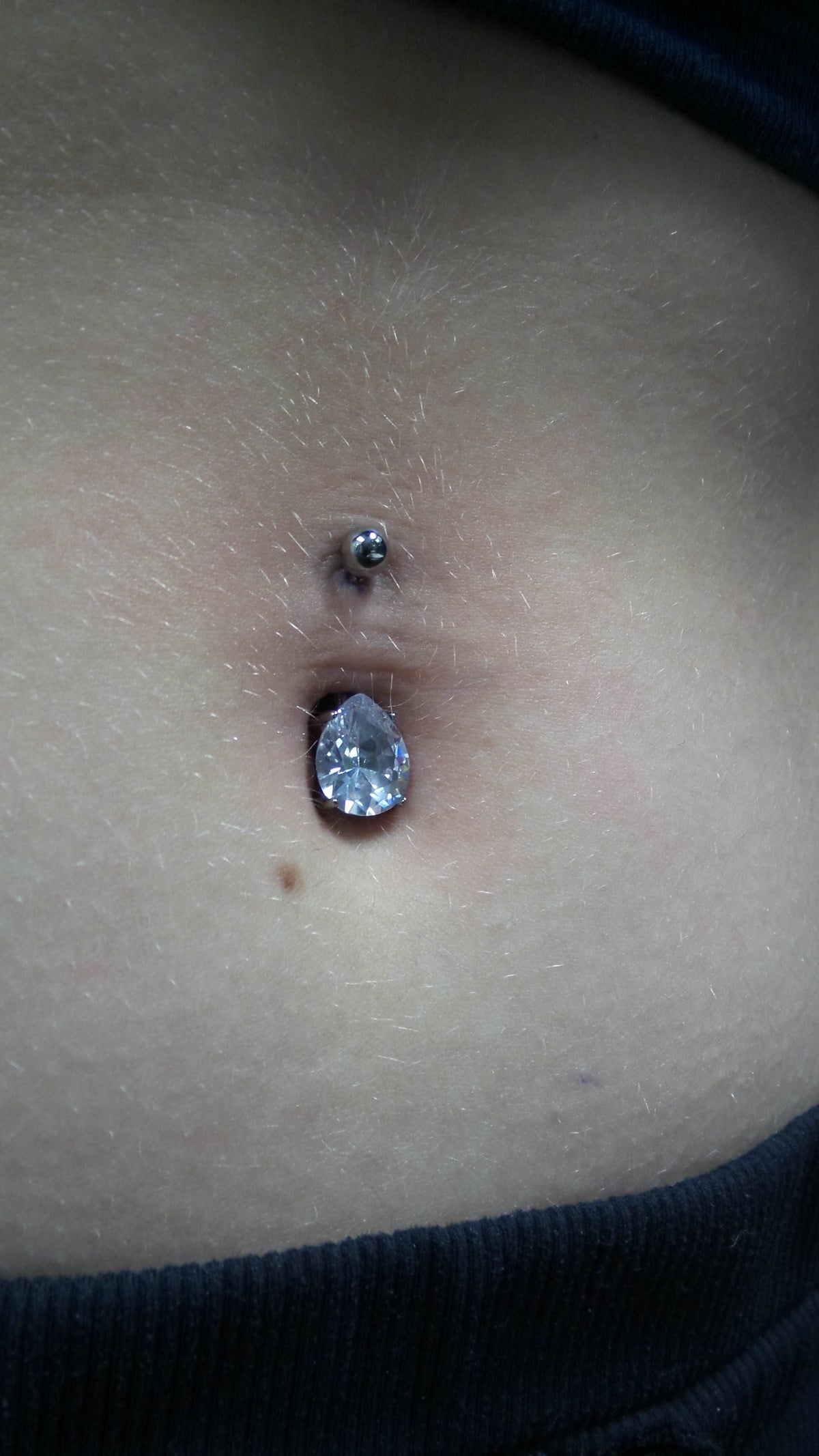 Blue gemstone jewelry worn in a navel piercing