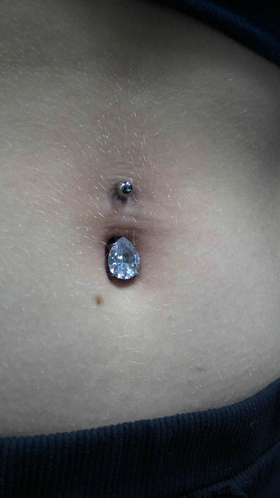Blue gemstone jewelry worn in a navel piercing