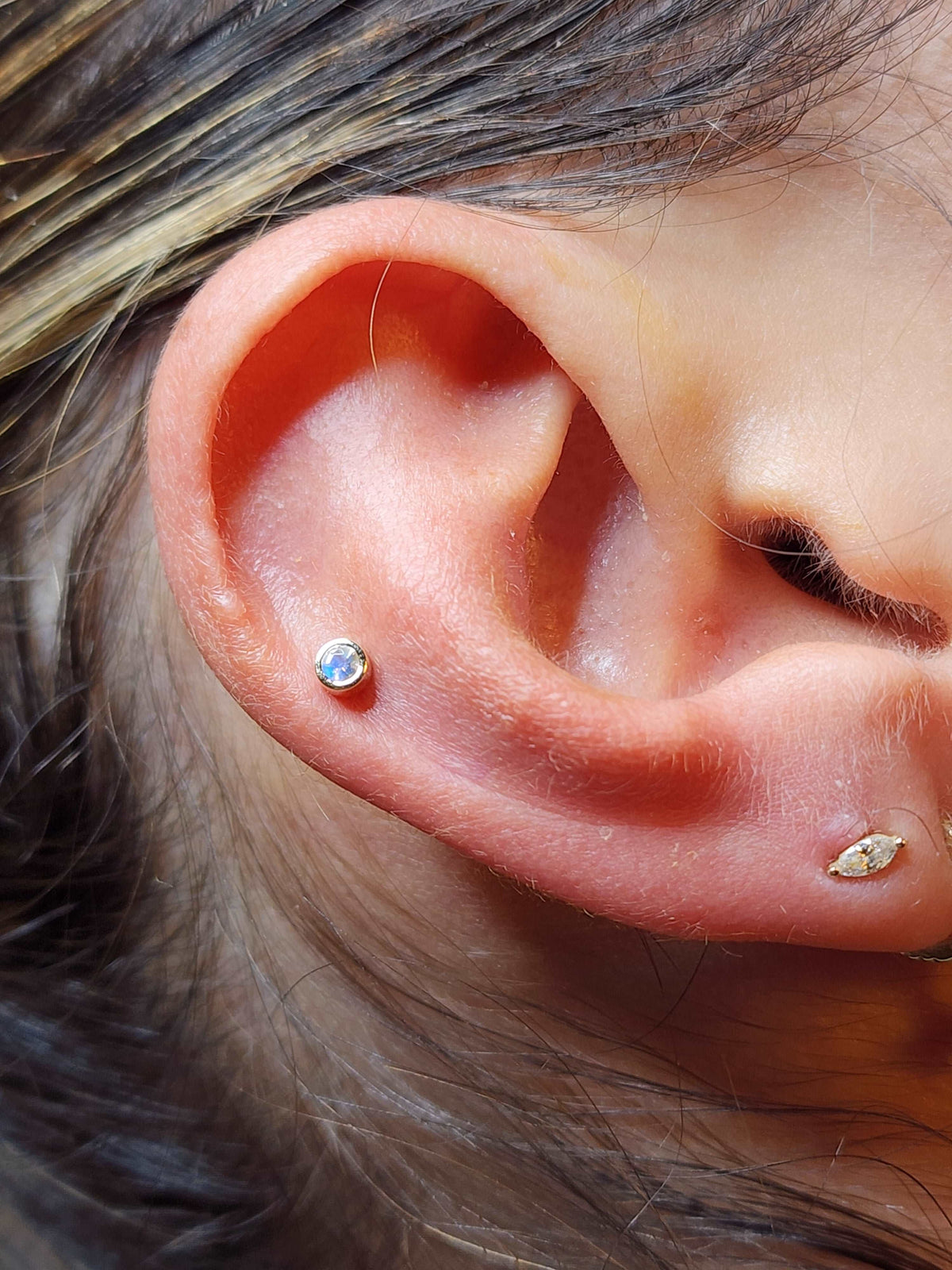 Clear gemstone jewelry in a cartilage piercing
