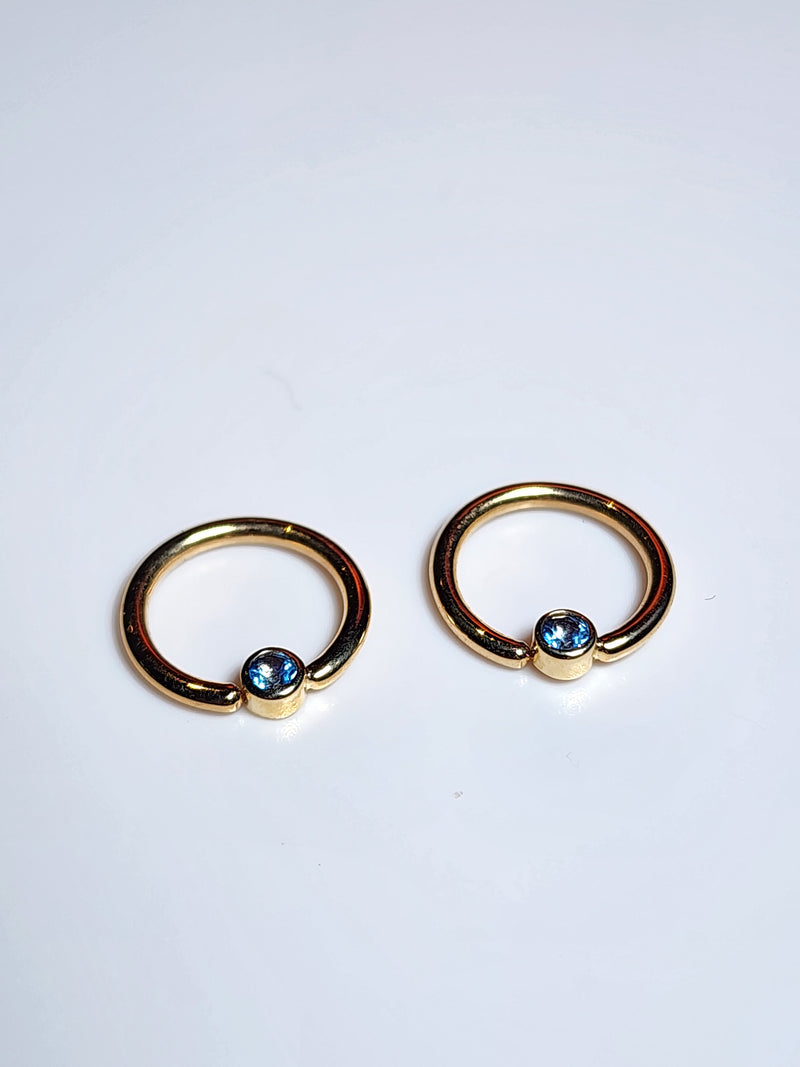 Solid 14kt Yellow and Rose Gold Forward facing gemmed seams. London Blue topaz in a Bezel set