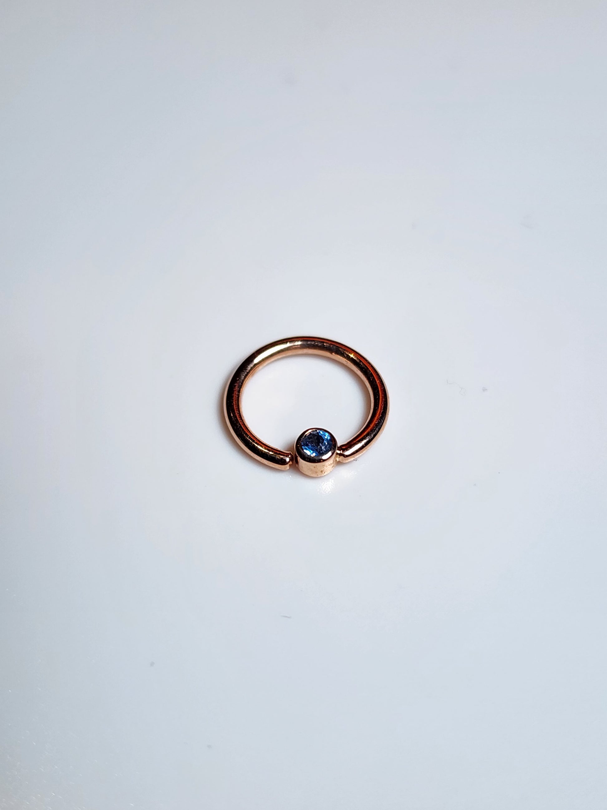 Solid 14kt Yellow and Rose Gold Forward facing gemmed seams. London Blue topaz in a Bezel set
