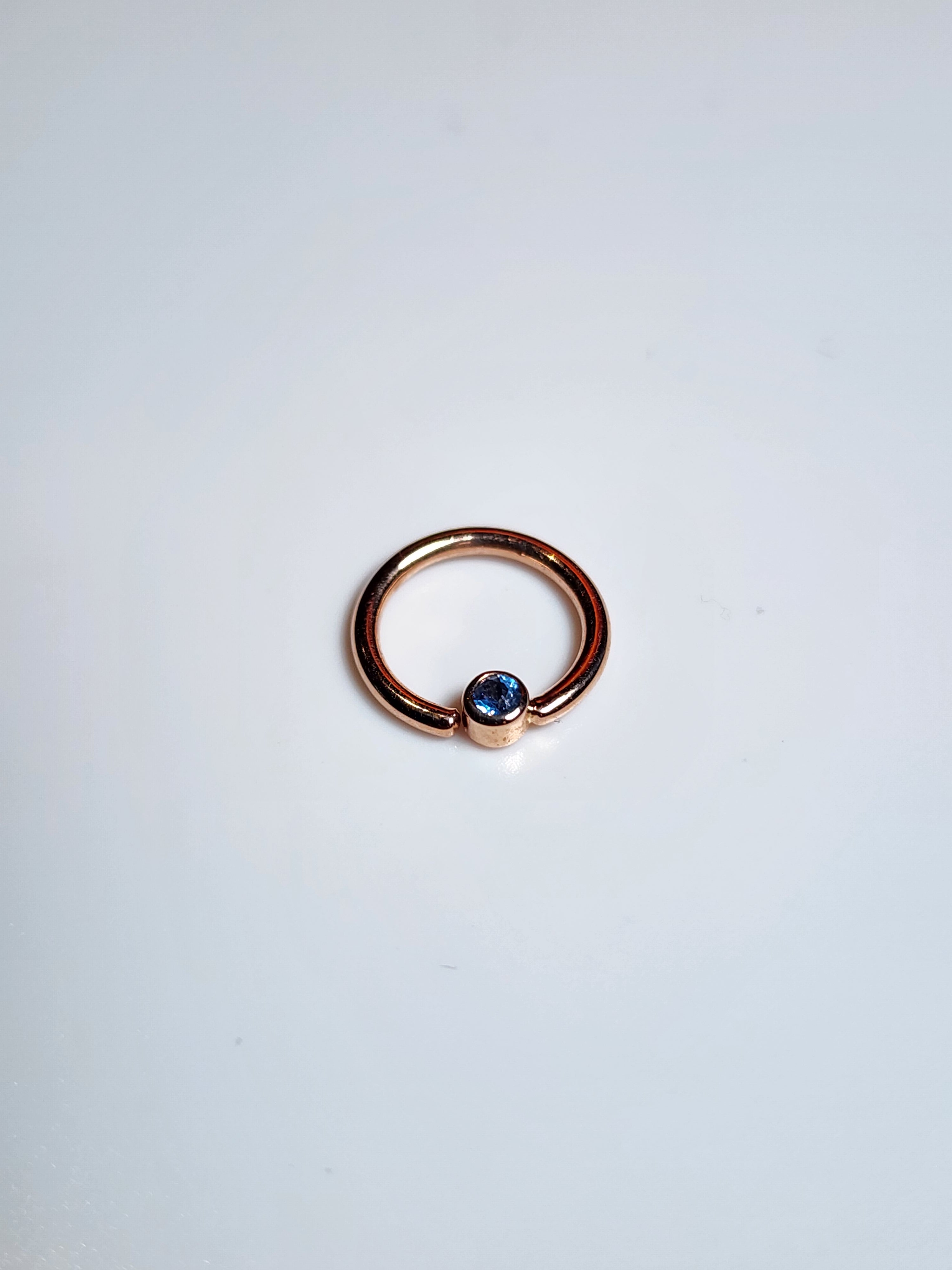 Solid 14kt Yellow and Rose Gold Forward facing gemmed seams. London Blue topaz in a Bezel set