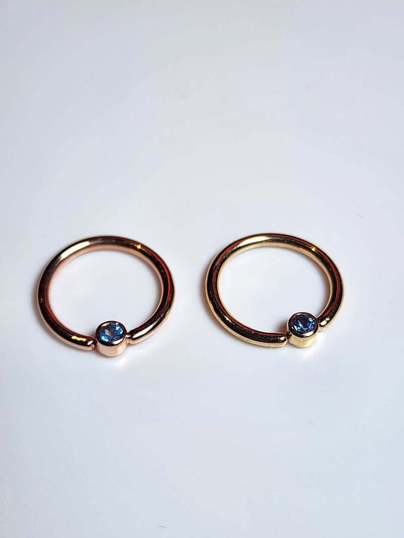 Solid 14kt Yellow and Rose Gold Forward facing gemmed seams. London Blue topaz in a Bezel set