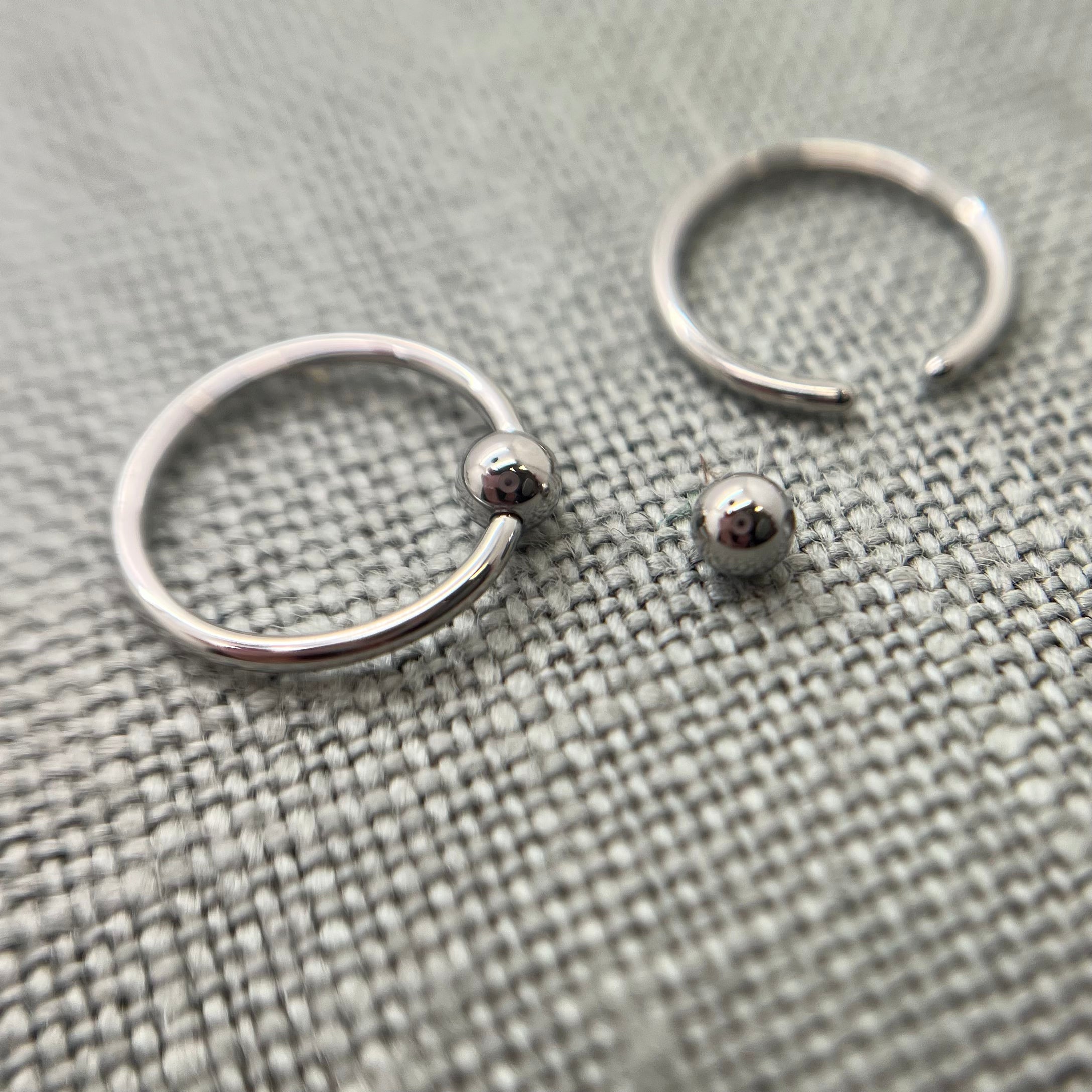 Stainless steel captive bead rings with one bead removed