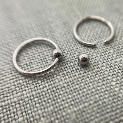 Stainless steel captive bead rings with one bead removed