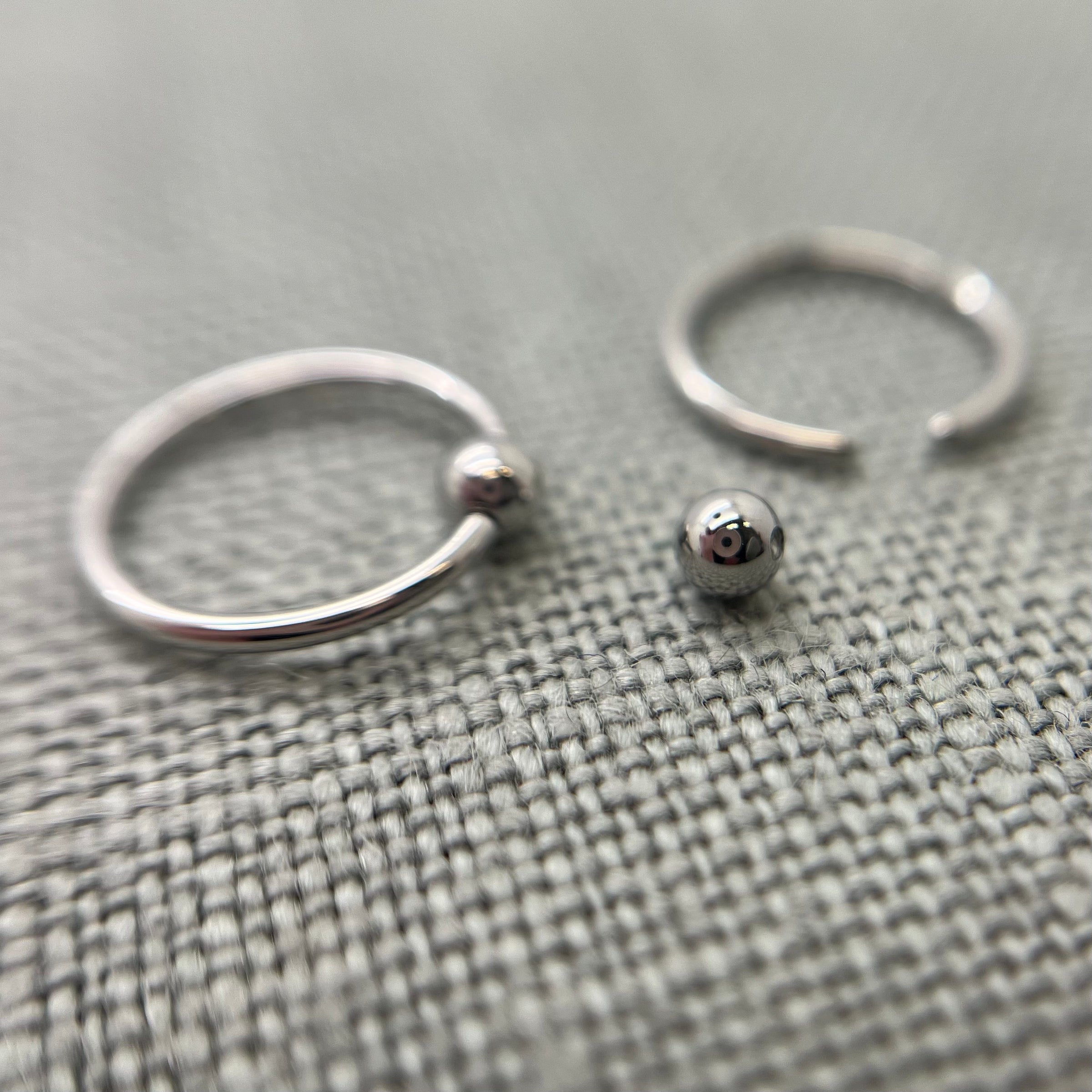 Stainless steel captive bead rings with one bead removed
