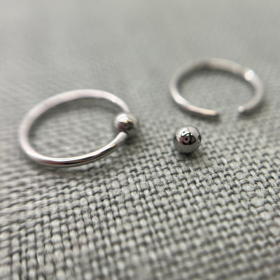 Stainless steel captive bead rings with one bead removed