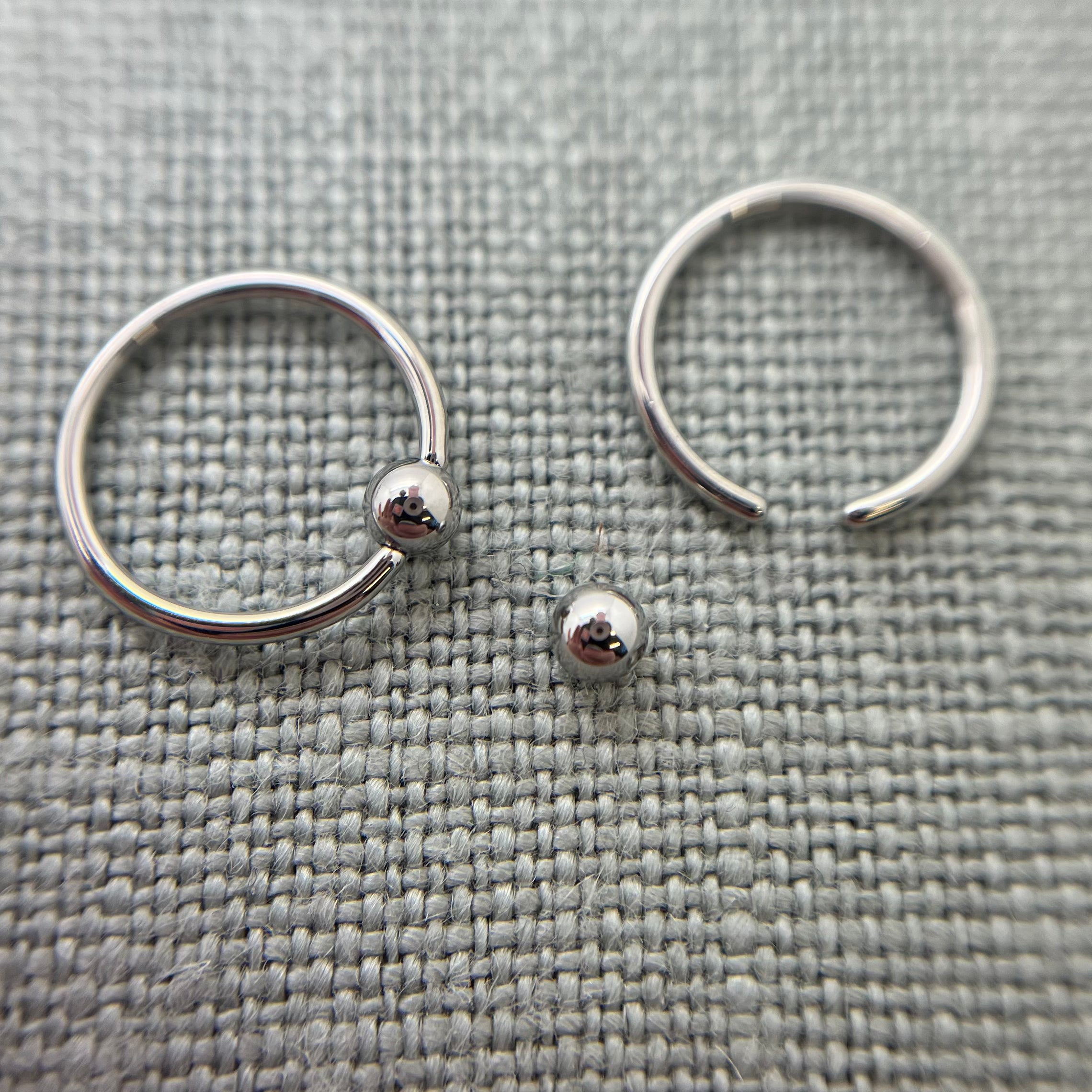 Stainless steel captive bead rings with one bead removed