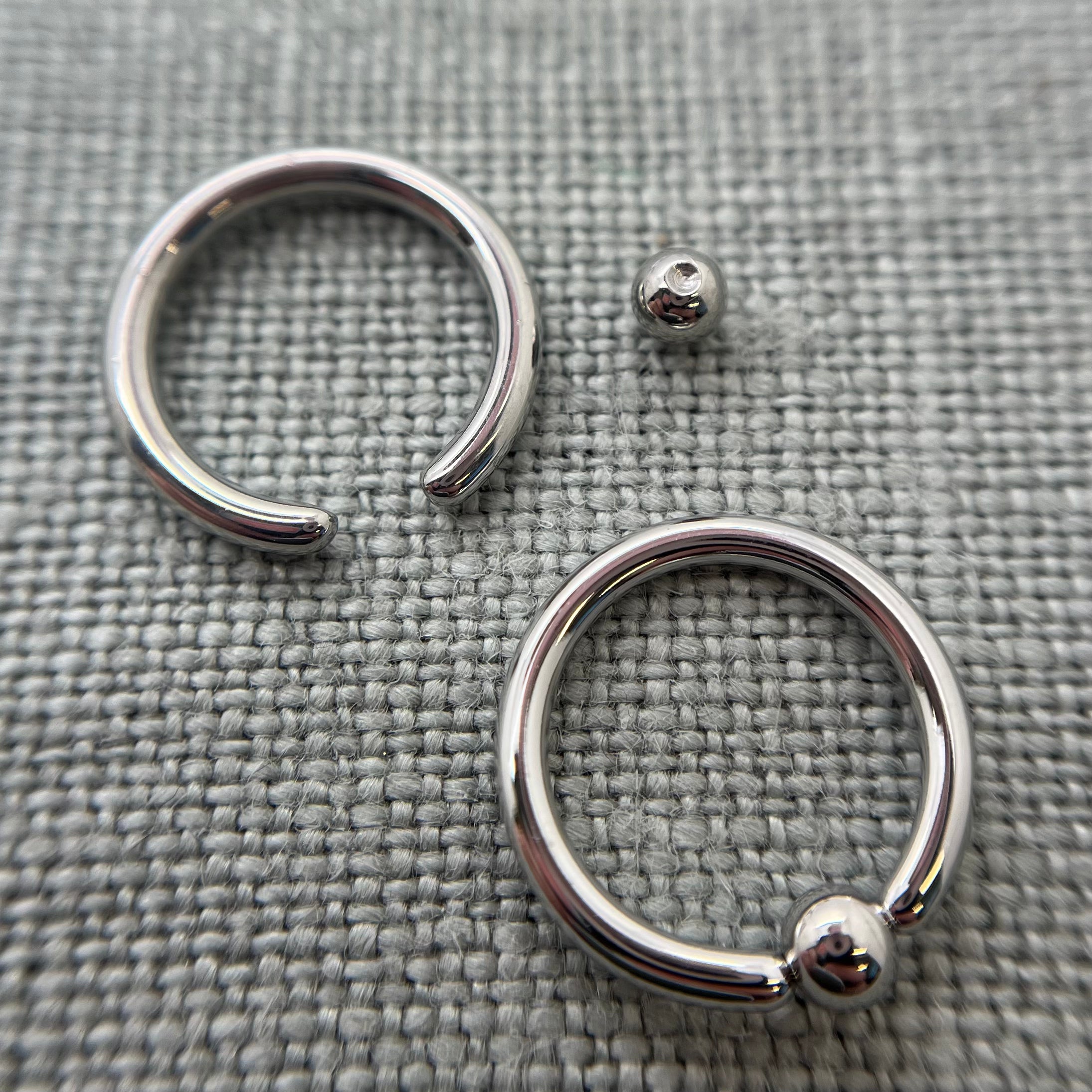 Stainless steel captive bead rings with a bead removed