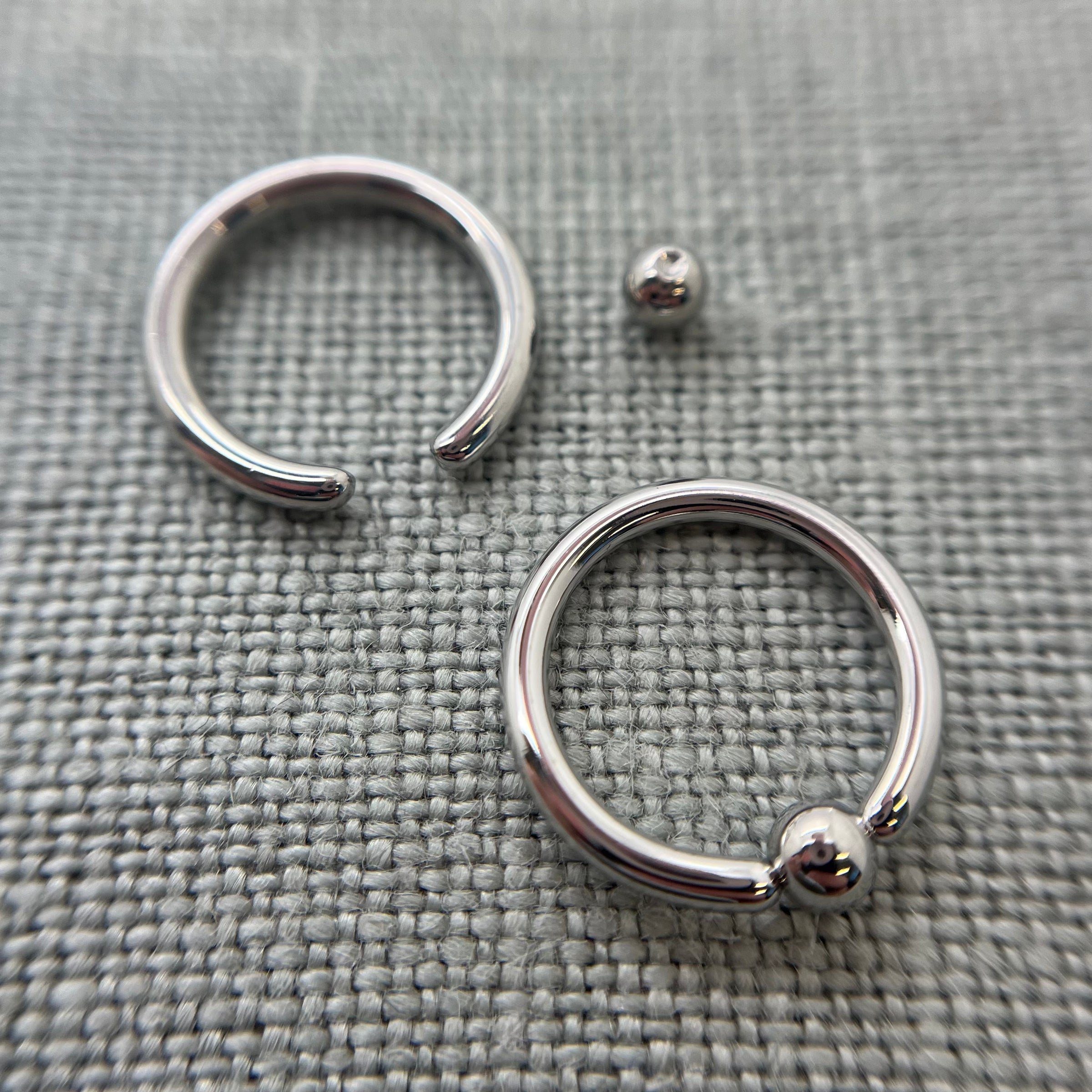 Stainless steel captive bead rings with a bead removed