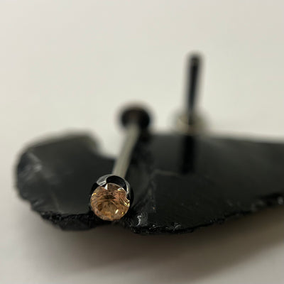 Champagne gemstone jewelry in a black niobium setting on dark stone