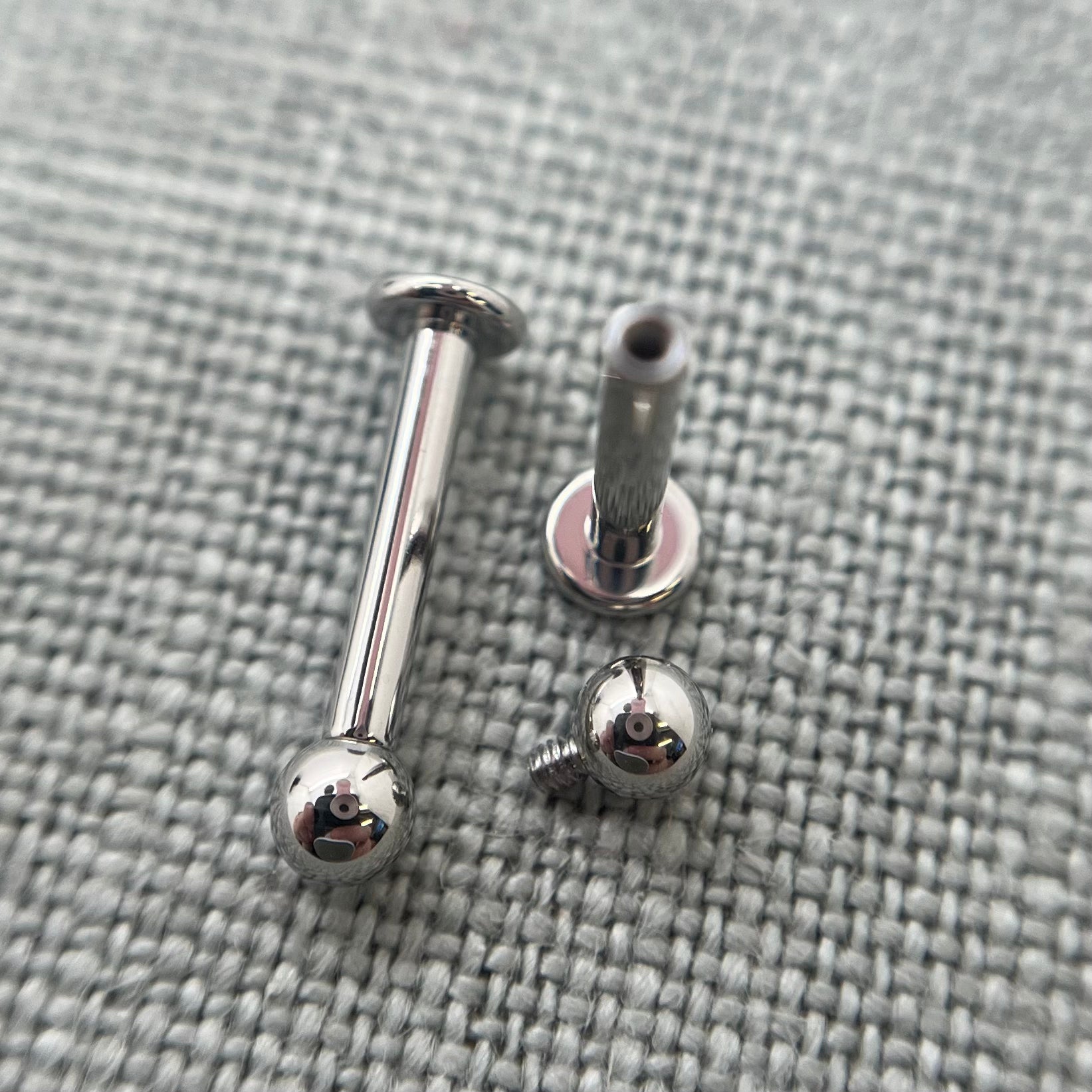 Stainless steel flat-back labrets with a threaded bead removed