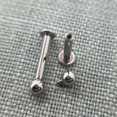Stainless steel flat-back labrets with a threaded bead removed