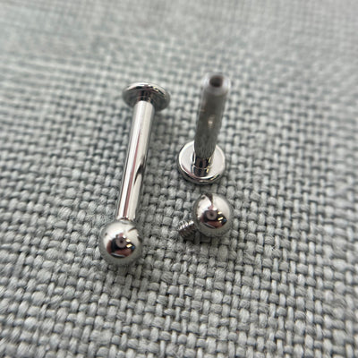 Stainless steel flat-back labrets with a threaded bead removed