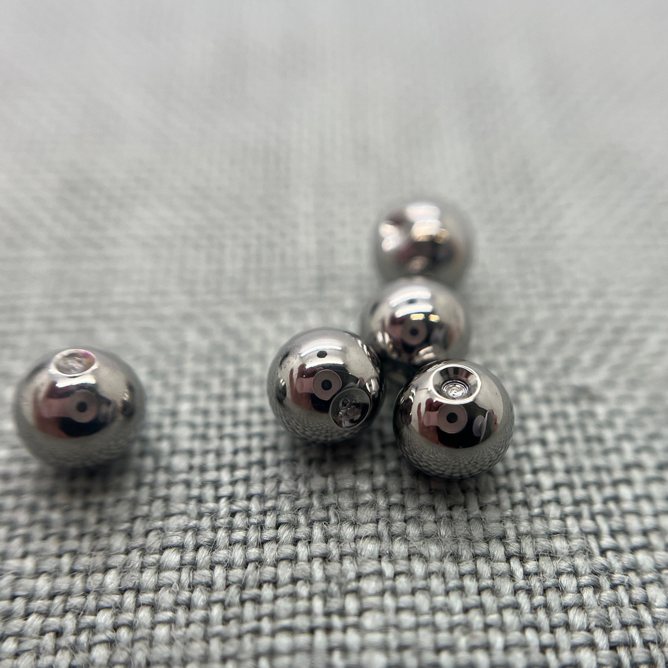 Polished stainless steel replacement beads for captive bead rings