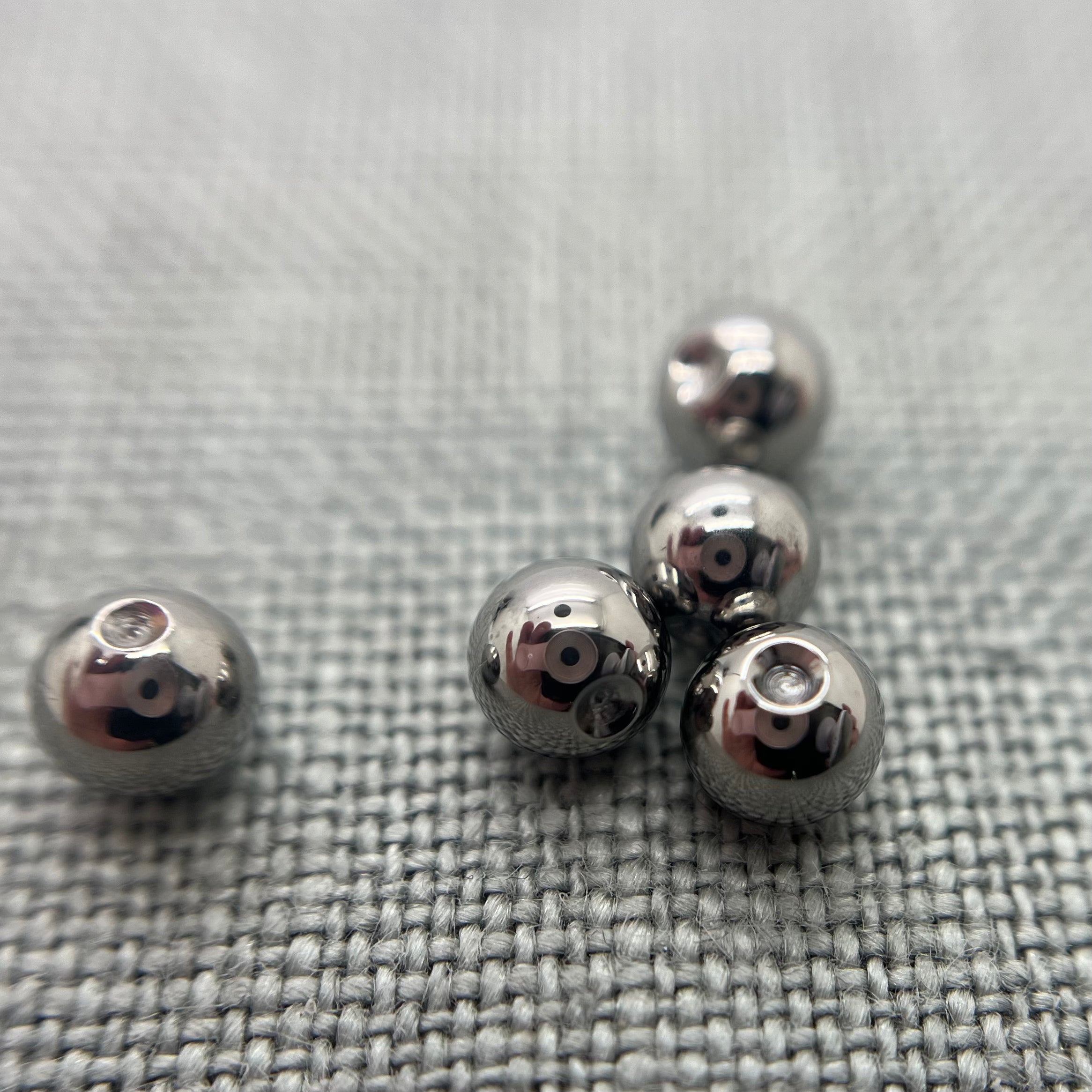 Polished stainless steel replacement beads for captive bead rings