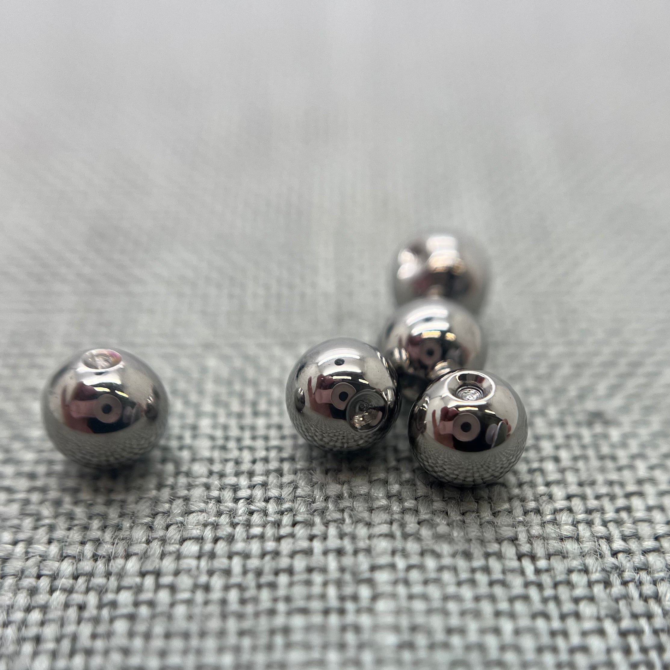 Polished stainless steel replacement beads for captive bead rings