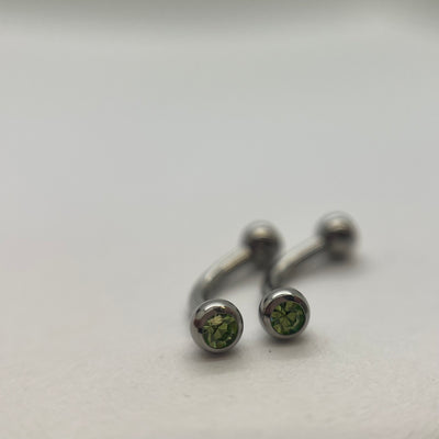 Stainless steel curved barbells with green cubic zirconia ends