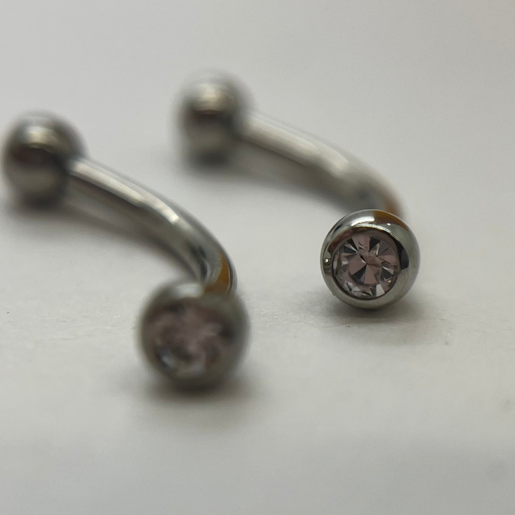 Stainless steel curved barbells with clear cubic zirconia ends