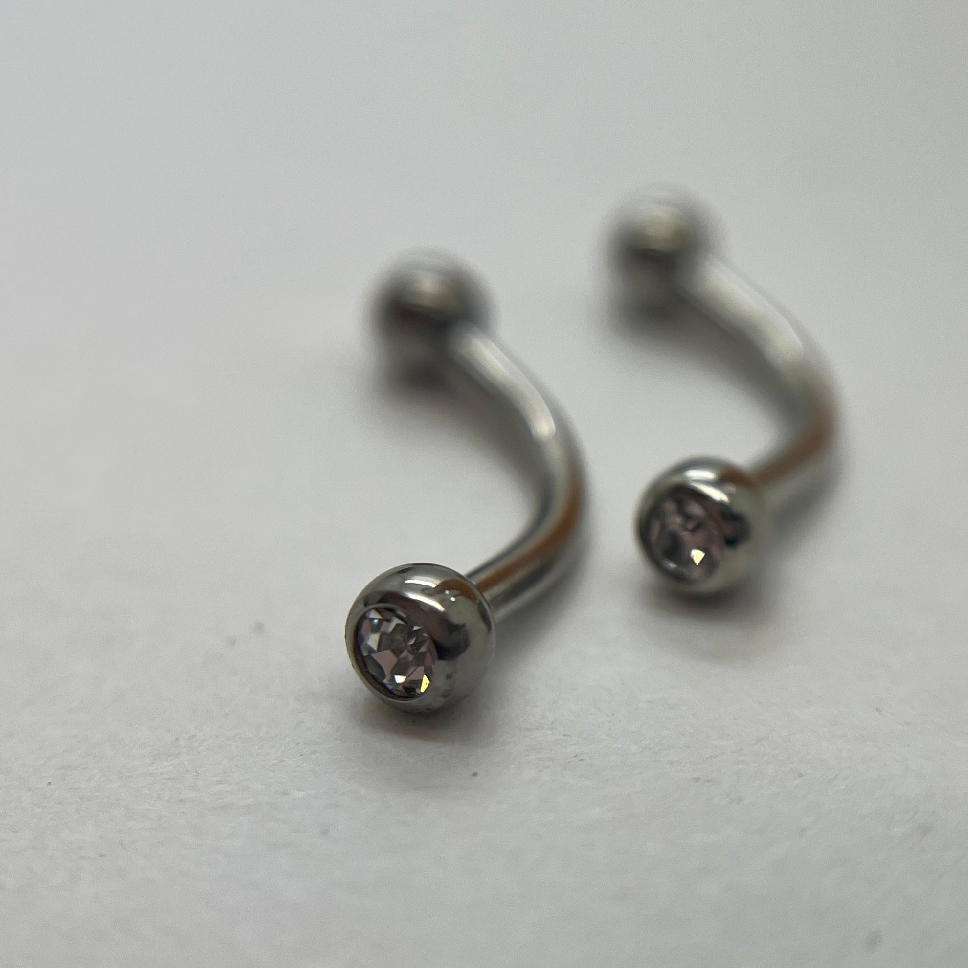 Stainless steel curved barbells with clear cubic zirconia ends
