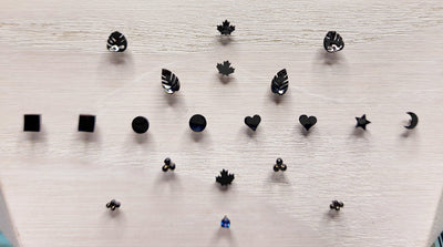 Black rhodium-plated gold jewelry ends in leaf, heart and geometric shapes