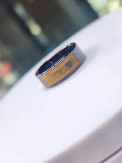 Dark ceramic NFC finger ring with its internal circuit visible