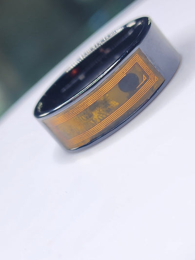 Dark ceramic NFC finger ring with its internal circuit visible