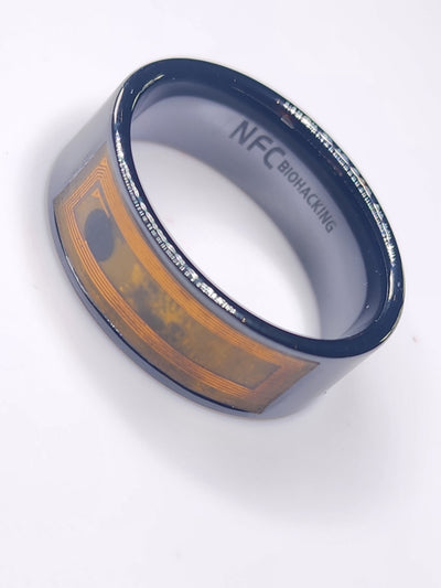 Dark ceramic NFC finger ring with its internal circuit visible