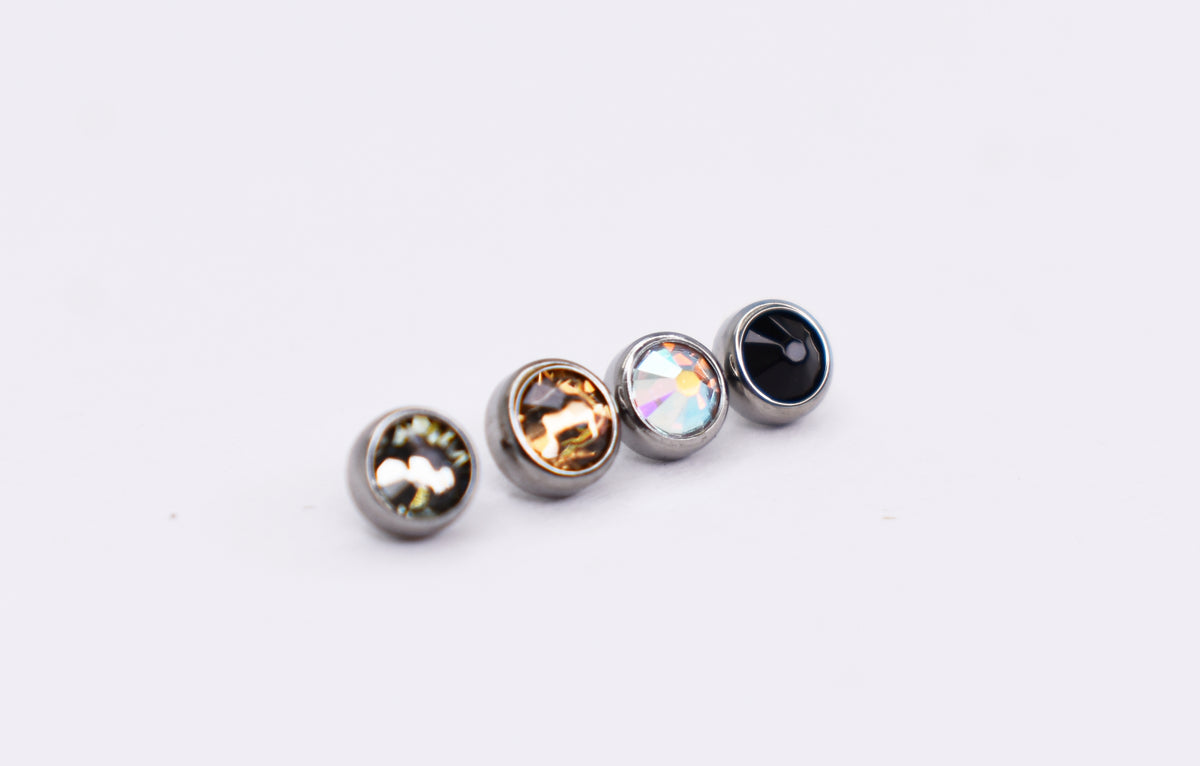 Bezel-set titanium gemstone beads in smoky, champagne, iridescent and black colours