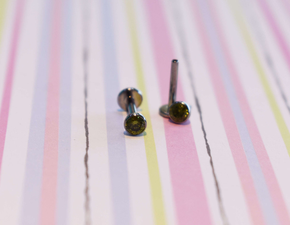 Flat-back jewelry with dark gemstone ends on pastel stripes