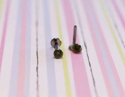 Flat-back jewelry with dark gemstone ends on pastel stripes
