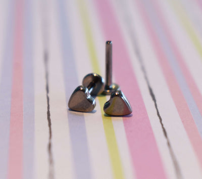 Heart-shaped jewelry ends beside a flat-back post