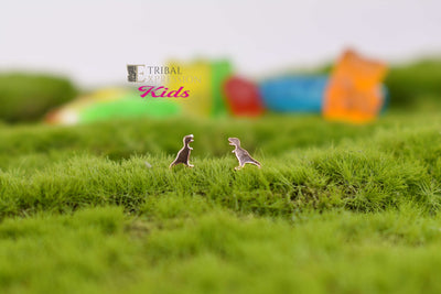 Small gold jewelry ends displayed on green moss with colourful props