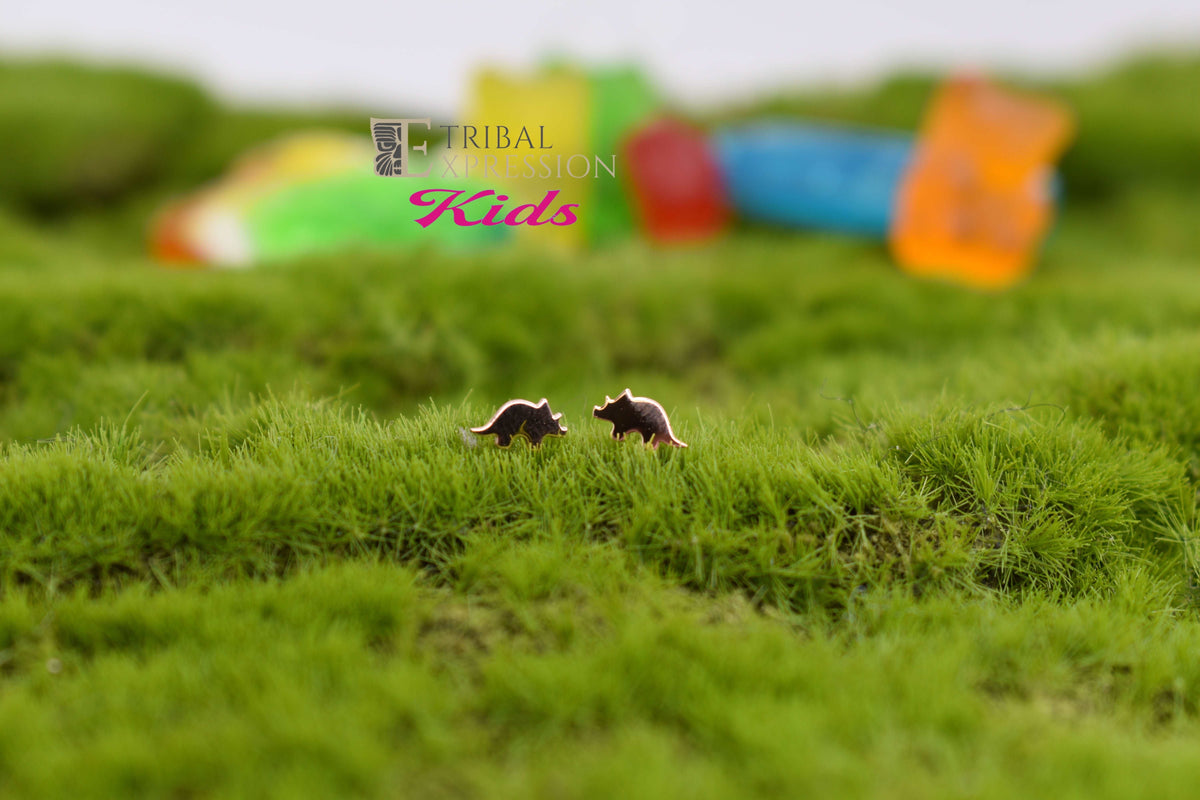 Gold jewelry ends displayed as a pair on green moss