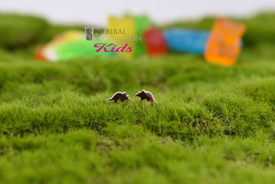 Gold jewelry ends displayed as a pair on green moss