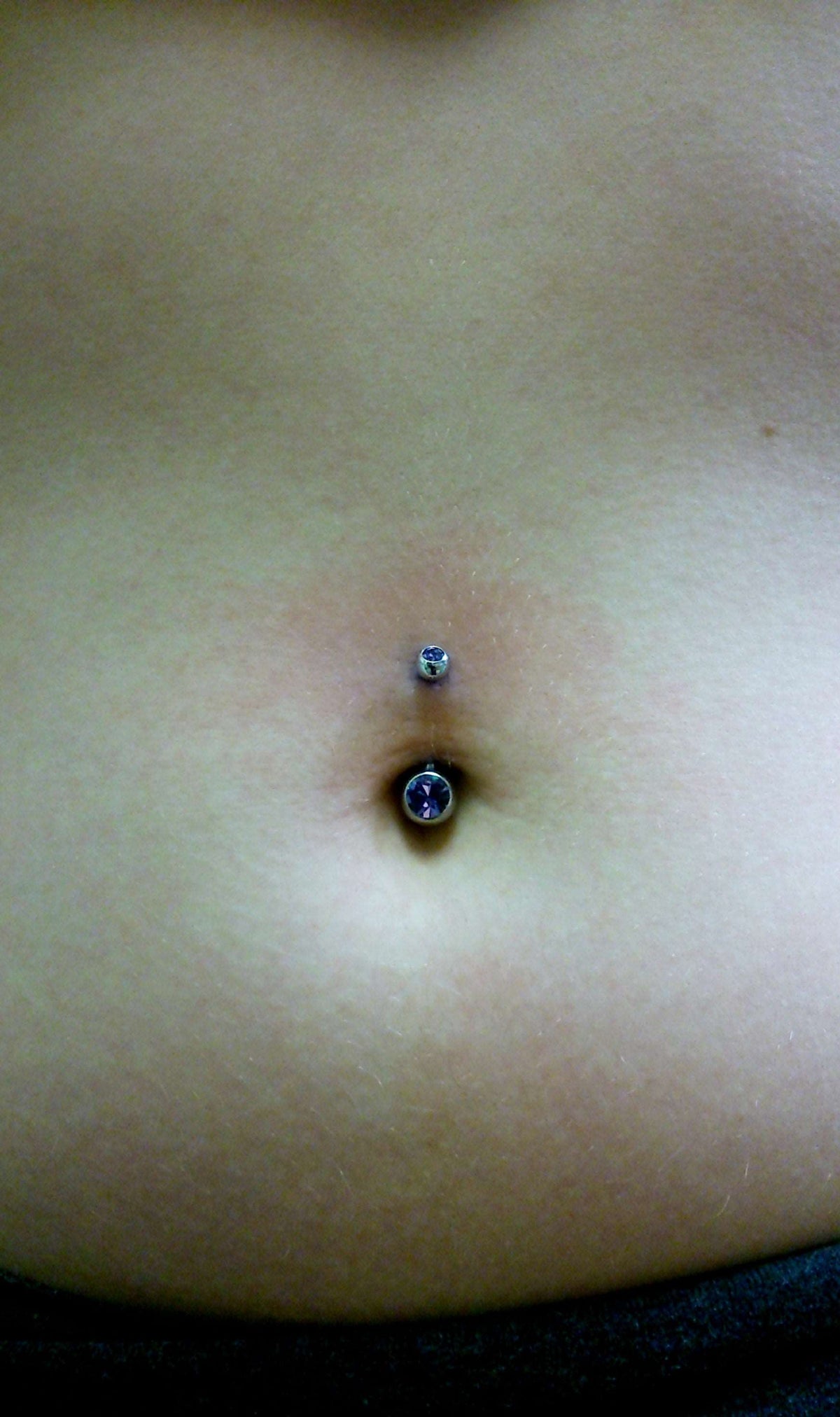 Blue gemstone jewelry worn in a navel piercing