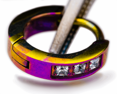Pink and yellow patterned titanium clicker with clear gemstones