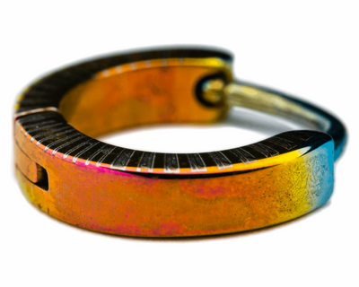 Titanium clicker with an orange band and dark striped edges