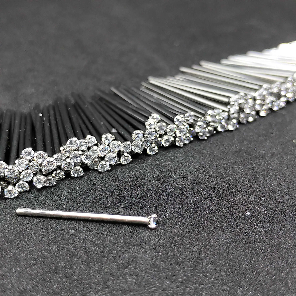Close-up of clear prong-set titanium nostril studs